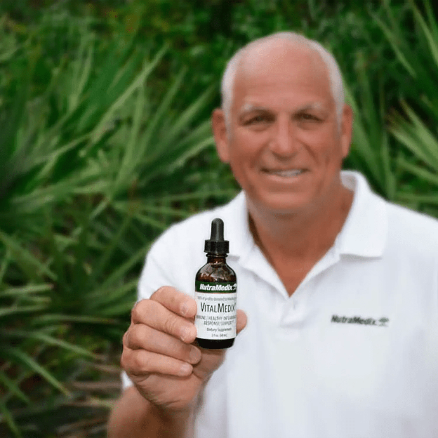 VitalMedix  2oz immune support liquid supplements used by an elderly man